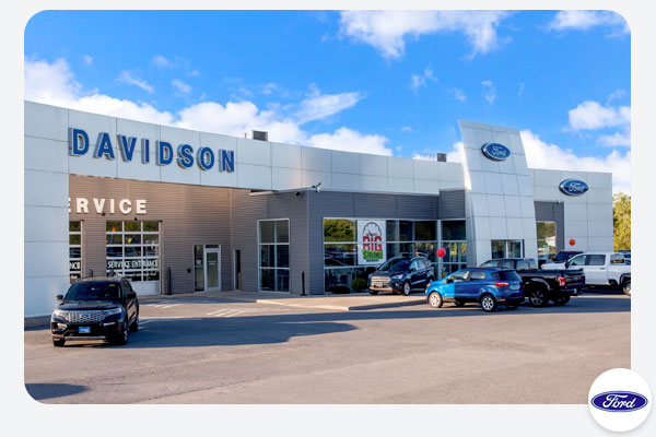Exterior of Davidson Ford Supercenter Automotive Dealership in Watertown NY with parked Ford truck and suv inventory in front of the store
