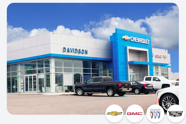 Davidson GM of Rome Dealership exterior in Rome, NY with a lineup of Chevrolet and GMC trucks and suvs